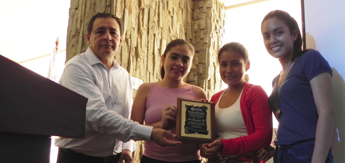 Students being awarded a plaque