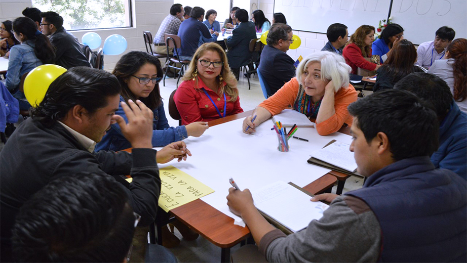 Participantes compartiendo ideas y criterios en las mesas de trabajo