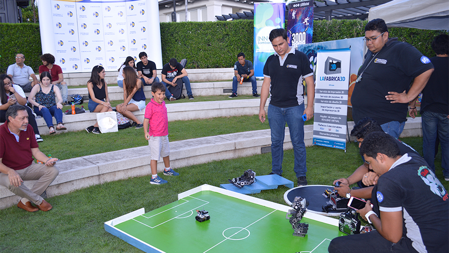 Members of the robotics club presenting their robots