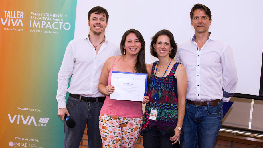 Paula Salazar (center) receives a recognition for attending 