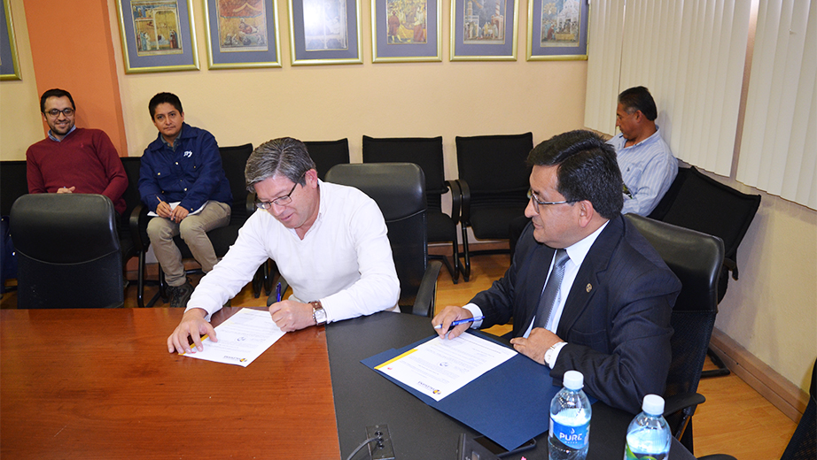 Juan Carpio, signing his designation as director of civil engineering
